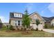 Charming two-story home with brick and siding exterior, complemented by a well-manicured lawn and a two-car garage at 9435 Liberty Hill Dr, Mint Hill, NC 28227