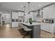 Modern kitchen with white cabinets, a large island with seating, stainless steel appliances, and stylish pendant lighting at 9435 Liberty Hill Dr, Mint Hill, NC 28227