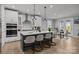 Open-concept kitchen featuring a large island with bar seating, modern appliances, and seamless flow into the dining area at 9435 Liberty Hill Dr, Mint Hill, NC 28227