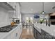 Bright kitchen features white cabinets, a farmhouse sink, stainless steel appliances, and an adjacent dining area at 9435 Liberty Hill Dr, Mint Hill, NC 28227