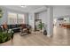 Living room with a leather couch, indoor plants, and a large mirror at 9435 Liberty Hill Dr, Mint Hill, NC 28227