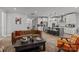 Open-concept living room and kitchen featuring a leather sofa, modern decor, and a central island with seating at 9435 Liberty Hill Dr, Mint Hill, NC 28227