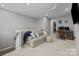 Cozy loft features a comfortable couch, ceiling fan, and a convenient computer desk, perfect for relaxation or work at 9435 Liberty Hill Dr, Mint Hill, NC 28227