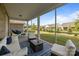 Inviting screened porch features stylish furniture, a cozy rug, and views of the serene backyard, perfect for relaxation at 9435 Liberty Hill Dr, Mint Hill, NC 28227