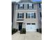 Charming townhouse exterior with light siding, black shutters, and attached one car garage and well maintained landscaping at 999 Rushing Ln # 13, Fort Mill, SC 29715