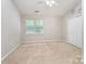 Spacious bedroom with carpet, ample closet space, and a large window providing natural light at 10223 Reindeer Way Ln, Charlotte, NC 28216