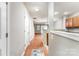 Bright hallway with hardwood floors, neutral walls, and seamless flow to the kitchen and living spaces at 10223 Reindeer Way Ln, Charlotte, NC 28216