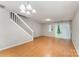 Bright living room featuring wood floors, stairs, a large glass sliding door and neutral walls at 10223 Reindeer Way Ln, Charlotte, NC 28216