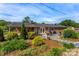 Home's backyard features a lush garden, patio area, and privacy fence at 110 Heritage Dr, Kings Mountain, NC 28086