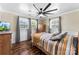 Comfortable bedroom with warm hardwood floors, three windows and ceiling fan at 110 Heritage Dr, Kings Mountain, NC 28086
