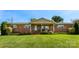 Charming brick home with well-manicured lawn and inviting covered front porch with chairs for relaxing at 110 Heritage Dr, Kings Mountain, NC 28086