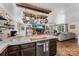 Gourmet kitchen view to living area with pot rack, hardwood floors, and an abundance of natural light at 110 Heritage Dr, Kings Mountain, NC 28086