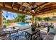 Outdoor covered patio offers ample seating, ceiling fan, and pool views for entertaining and relaxation at 110 Heritage Dr, Kings Mountain, NC 28086