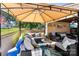 Outdoor covered patio with comfortable seating, ceiling fan, and festive decor at 110 Heritage Dr, Kings Mountain, NC 28086