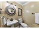 Stylish powder room features a decorative mirror, pedestal sink, and charming wall decor at 110 Heritage Dr, Kings Mountain, NC 28086