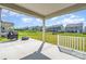 Covered back patio with concrete flooring overlooking a grassy yard at 11116 Godwit Ln, Charlotte, NC 28278