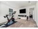 Dedicated exercise room featuring a Peloton bike and mounted TV for a great workout at 11116 Godwit Ln, Charlotte, NC 28278