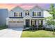 Charming two-story home with a well-manicured lawn and inviting front porch at 11116 Godwit Ln, Charlotte, NC 28278