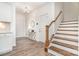Bright foyer with hardwood floors, a staircase, and an elegant light fixture at 11116 Godwit Ln, Charlotte, NC 28278