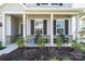 Inviting front porch with comfortable seating and manicured landscaping at 11116 Godwit Ln, Charlotte, NC 28278
