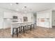 Bright kitchen with white cabinetry, stainless steel appliances, pendant lighting, and a spacious center island with seating at 11116 Godwit Ln, Charlotte, NC 28278