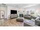 Cozy living room with a fireplace, large TV, and stylish gray couches at 11116 Godwit Ln, Charlotte, NC 28278