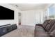 Cozy living room featuring a leather couch, media center, and plenty of natural light at 11116 Godwit Ln, Charlotte, NC 28278