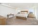 Bright main bedroom features neutral decor, tray ceiling, and wood furniture at 11116 Godwit Ln, Charlotte, NC 28278