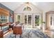 Bright office space featuring hardwood floors, a modern desk, and large windows offering natural light and a view to the backyard at 127 Fantasy Ln, Mooresville, NC 28117