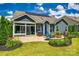 Backyard view with a patio, a seating area, a well-maintained lawn, and solar panels at 129 Hawks Creek Pkwy, Fort Mill, SC 29708