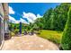 Backyard patio featuring an outdoor kitchen, a seating area, and lush landscaping at 129 Hawks Creek Pkwy, Fort Mill, SC 29708