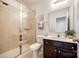 Tiled bathroom features a glass enclosed shower, a sink with modern fixtures, and neutral decor at 129 Hawks Creek Pkwy, Fort Mill, SC 29708
