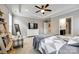 Bright bedroom features a trey ceiling, soft natural light, an ensuite bathroom, and a stylish armchair at 129 Hawks Creek Pkwy, Fort Mill, SC 29708