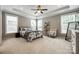 Bright bedroom features a trey ceiling, soft natural light, and a stylish armchair and decorative ladder at 129 Hawks Creek Pkwy, Fort Mill, SC 29708