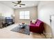 Second floor bonus room featuring a purple sofa, a television, and a modern ceiling fan at 129 Hawks Creek Pkwy, Fort Mill, SC 29708