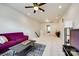 Second floor bonus room with a purple sofa, large windows, modern ceiling fan and neutral carpet at 129 Hawks Creek Pkwy, Fort Mill, SC 29708