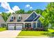 Charming home featuring a manicured lawn, lovely landscaping, and a convenient two-car garage at 129 Hawks Creek Pkwy, Fort Mill, SC 29708