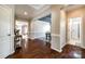 Open hallway with hardwood floors leading to various rooms and a clear view of the bathroom at 129 Hawks Creek Pkwy, Fort Mill, SC 29708