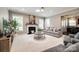 Comfortable living room with a fireplace, gray sofa, neutral walls, and large windows for ample natural light at 129 Hawks Creek Pkwy, Fort Mill, SC 29708