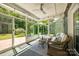 Inviting sunroom with lots of natural light, wicker furniture, and views of the backyard at 129 Hawks Creek Pkwy, Fort Mill, SC 29708