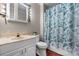 This bathroom features a vanity and toilet with a decorative shower curtain at 1330 5Th Ne St # 11, Hickory, NC 28601