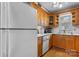 Practical kitchen with white appliances and wooden cabinets at 1330 5Th Ne St # 11, Hickory, NC 28601