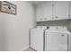 A tidy laundry room with white washer and dryer and upper cabinets at 1330 5Th Ne St # 11, Hickory, NC 28601