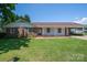 Charming brick home featuring a well-manicured lawn, covered porch, and convenient carport at 1613 Spangler Dr, Shelby, NC 28150