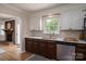 Kitchen features stainless appliances, undermount sink, and views into the breakfast nook and brick fireplace at 1613 Spangler Dr, Shelby, NC 28150