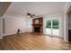 Spacious living room featuring hardwood floors, a brick fireplace, and natural light at 1613 Spangler Dr, Shelby, NC 28150