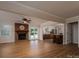 Open-concept living room with hardwood floors, a brick fireplace, and sliding glass doors to pool at 1613 Spangler Dr, Shelby, NC 28150