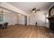 Spacious living room featuring hardwood floors, a brick fireplace, and modern lighting at 1613 Spangler Dr, Shelby, NC 28150