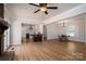 Open-concept living space features hardwood floors, brick fireplace, and a kitchen with island seating at 1613 Spangler Dr, Shelby, NC 28150