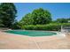 Refreshing pool featuring a built-in spa, surrounded by lush greenery and a spacious patio at 1613 Spangler Dr, Shelby, NC 28150